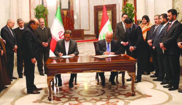 In this handout provided by the Iraqi prime minister’s office, Iran’s First Vice President Eshaq Jahangiri (C-L) and Iraq’s Prime Minister Haider Al-Abadi (C-R) sign memorandums of understanding in a number of different fields, in Baghdad, Iraq, on February 16, 2015. (Asharq Al-Awsat/Iraqi prime minister’s office/HO) 