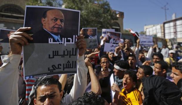 A protester holds up a poster of Yemen's former president Abd Rabbuh Mansur Hadi during an anti-Houthi demonstration in Sana’a, Yemen, on February 21, 2015. (Reuters/Khaled Abdullah) 