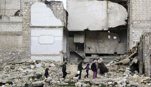 Children walk on the debris of a damaged building in Al-Myassar neighborhood of Aleppo on February 16, 2015. (Reuters/Hosam Katan)