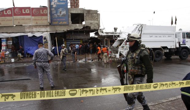 A member of the Iraqi security forces walks past the site of a bomb attack in Baghdad on February 7, 2015. (Reuters/Khalid Al-Mousily)