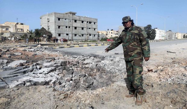 Senior army special forces commander Fadel Al-Hassi points at the site of an explosion in Benghazi on February 6, 2015. (Reuters/Esam Omran Al-Fetori)