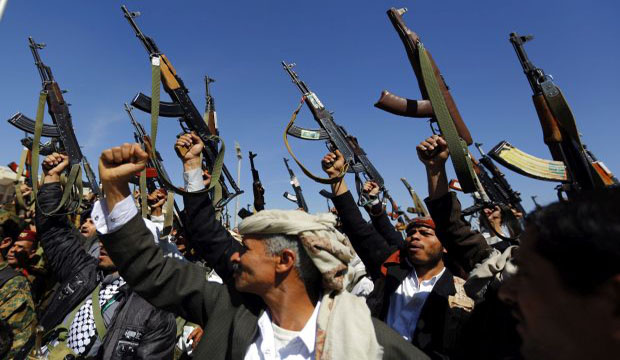 Tribal gunmen loyal to the Shi'ite Houthi movement shout slogans and hold weapons during a gathering in Sana'a, Yemen, on February 4, 2015. (EPA/Yahya Arhab)