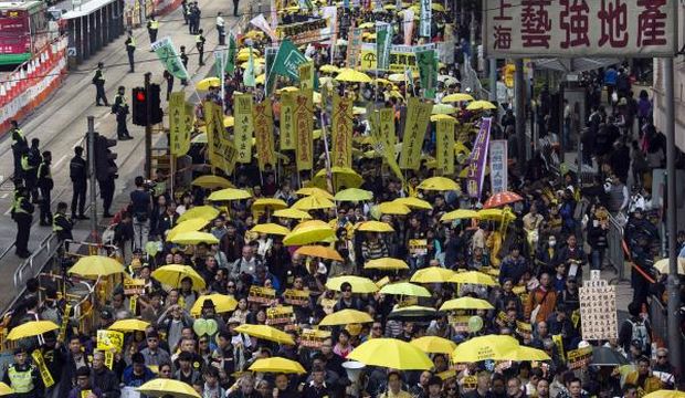 Thousands of pro-democracy protesters hold up yellow umbrellas, symbols of the Occupy Central movement, during a march in the streets to demand universal suffrage in Hong Kong. (Reuters)