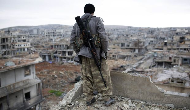 A Kurdish sniper looks down on the Syrian city of Kobani on January 30, 2015, a few days after ISIS withdrew from the city.  (AP Photo, File)