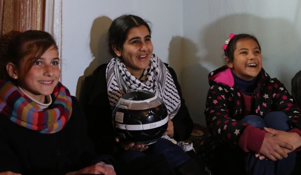 Malak Al-Khatib (C), a 14-year-old schoolgirl who was jailed in an Israeli prison for six weeks, sits with friends at her home in the West Bank village of Beitin after she was released the previous day, on February 14, 2015. (AFP Photo/Abbas Momani)