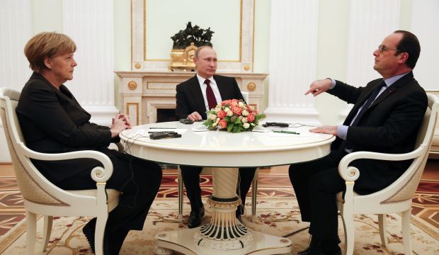 German Chancellor Angela Merkel and Russia's President Vladimir Putin (C) listen to French President Francois Hollande during a meeting to find a resolution to the conflict in Ukraine, in Moscow, on February 6, 2015. (Reuters/Maxim Zmeyev)