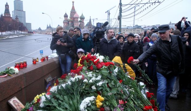 People place flowers  at the spot where Russian opposition leader Boris Nemtsov was shot dead, in the center of Moscow on February 28, 2015. (AFP Photo/Sergei Gapon)