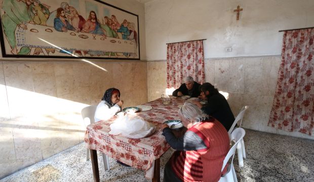 Syrian Christians share a meal at the Saint Elias center for the elderly in the rebel-held side of Aleppo on November 18, 2014. (Zein Al-Rifai/AFP/Getty Images)