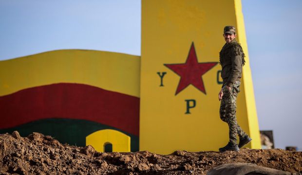 A fighter of the Kurdish People’s Protection Units (YPG) stands atop a sand barricade in the northeastern province of Al-Hasakah, Syria, on February 2, 2015. (Reuters/Rodi Said)