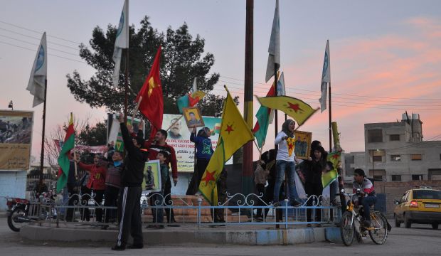 Kurds celebrate in Syria's northeastern city of Qamishli on February 27, 2015 after Kurdish fighters seized a key ISIS stronghold. (AFP Photo/Delil Souleiman)