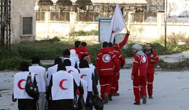 Members of the Syrian Arab Red Crescent escort civilians with medical needs in the rebel-controlled area of Aleppo to the government-controlled area to seek treatment on February 1, 2015. (Reuters/Ammar Abdullah)