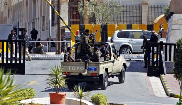 Heavily armed Yemenis guard the entrance to the hotel where representatives of warring factions in Yemen are attending closed-door talks under UN auspices in Sana'a, Yemen, on February 5, 2015. (EPA/Yahya Arhab)