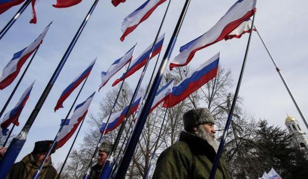 Members of pro-Russian self-defense units hold Russian and Crimean flags during a meeting to celebrate the first anniversary of Russia's annexation of Ukraine's Black Sea peninsula of Crimea, in central Simferopol, on March 16, 2015. (Reuters/Maxim Shemetov)