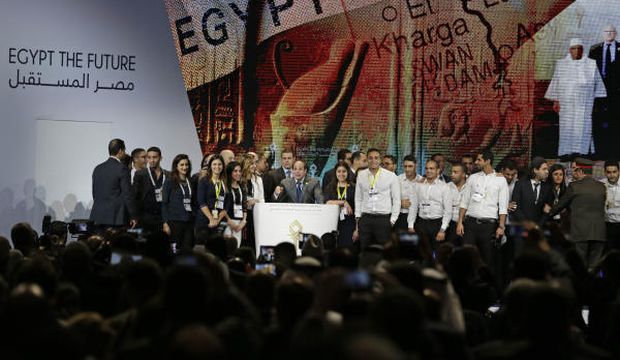 Surrounded by young conference organizers, Egyptian President Abdel-Fattah El-Sisi speaks during the final day of the Egypt Economic Development Conference (EEDC) that has injected billions of dollars' worth of aid and investment into his country, in Sharm El-Sheikh, Egypt, on March 15, 2015. (AP Photo/Hassan Ammar)