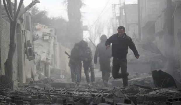 Residents look for survivors amid debris of collapsed buildings after what activists said were airstrikes by forces loyal to Syria's President Bashar Al-Assad in Marj Al-Sultan, in the eastern Damascus suburb of Ghouta, on February 27, 2015. (Reuters/Amer Almohibany)