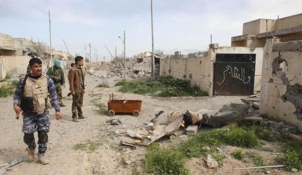 Kurdish Peshmerga forces inspect a destroyed building belonging to Islamic State of Iraq and Syria (ISIS) militants on the outskirts of Tel Alwad, west of the city of Kirkuk, on March 9, 2015. (Reuters/Ako Rasheed) 