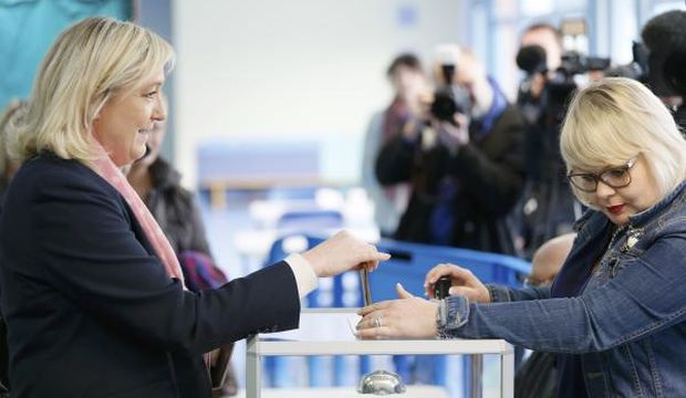 France's far-right National Front leader Marine Le Pen (L) casts her ballot as she votes in Henin-Beaumont, northern France, on March 22, 2015. France goes to the polls in a two-round departmental election for local officials on March 22 and March 29. (Reuters/Gonzalo Fuentes)