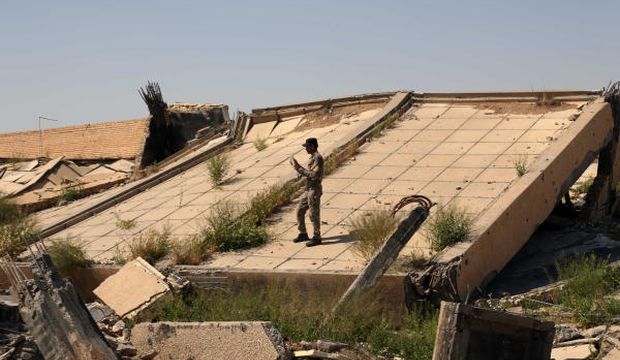 An Iraqi soldier takes photos of the demolished tomb of former Iraqi president Saddam Hussein, in Tikrit, Iraq, on March 15, 2015, following fighting between Islamic State of Iraq and Syria (ISIS) militants and Iraqi forces. (AP Photo/Khalid Mohammed, File)