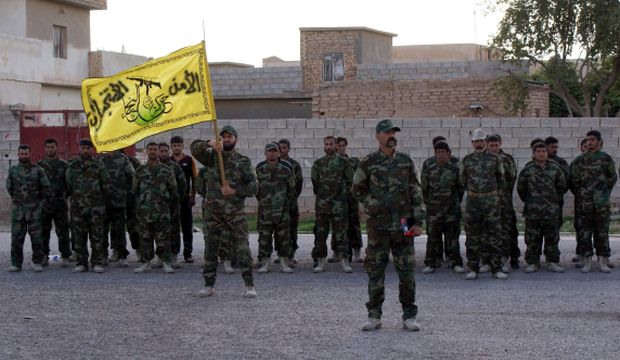 A picture made available on March 5, 2015 shows members of the Iraqi Shi'ite militia Kata'ib Hezbollah taking part in a training course at a military base in Jallam town, near Samarra, northern Iraq, on March 4, 2015. (EPA/Baraa Kanaan)