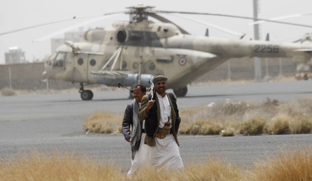 Shiite rebels, known as Houthis, walk on the tarmac of the Sanaa International Airport in Sanaa, Yemen, Saturday, March 28, 2015.  (AP Photo/Hani Mohammed)