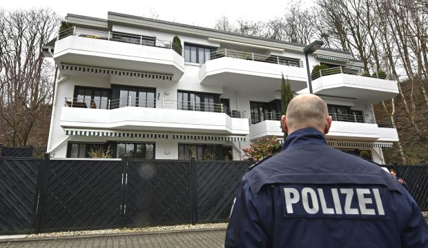 A police officer stands in front of an apartment where the co-pilot of the crashed Germanwings airliner jet is supposed to have lived in Dusseldorf, Germany, on March 26, 2015. (AP Photo/Martin Meissner)