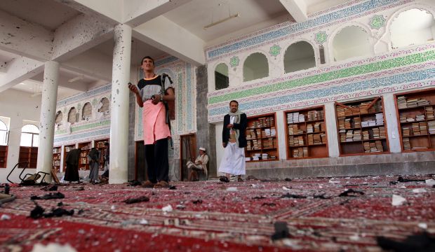 Yemeni armed men inspect the damage following a bomb explosion at the Badr mosque in southern Sana'a on March 20, 2015. (AFP/Mohammed Huwais)