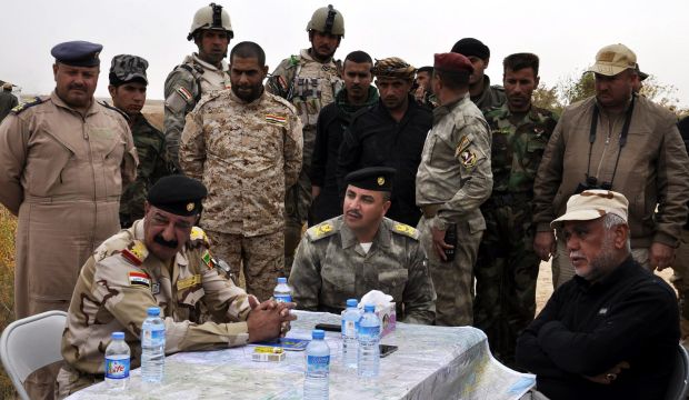 Head of the Iraqi Shi'ite militia the Badr Organization Hadi Al-Ameri (R) meets with military commanders near Samarra in northern Iraq, on March 4, 2015. (EPA/Ali Mohammed)