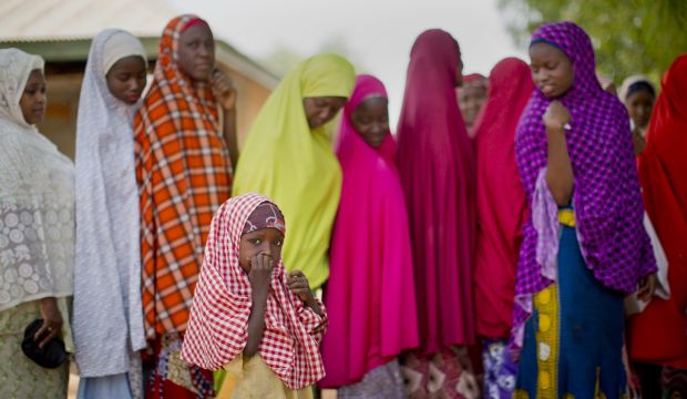Nigerian women from the Hausa tribe stand in line to validate their voting cards at a polling station located in Daura, the home town of opposition candidate Gen. Muhammadu Buhari, on March 28, 2015. (AP Photo/Ben Curtis)