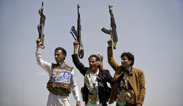 Supporters of Ahmed Ali Abdullah Saleh, the son of Yemeni former President Ali Abdullah Saleh, hold their weapons as they chant slogans during a demonstration demanding presidential elections be held and the younger Saleh run for the office, in Sanaa, Yemen, Tuesday, March 10, 2015. (AP Photo/Hani Mohammed)