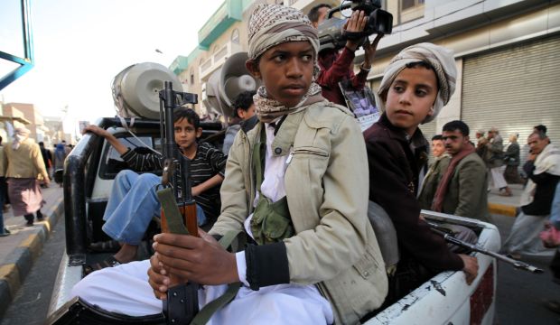 Boys supporting the Houthi movement ride on the back of a patrol truck during a demonstration in Sana'a on March 13, 2015. (Reuters/Mohamed Al-Sayaghi)
