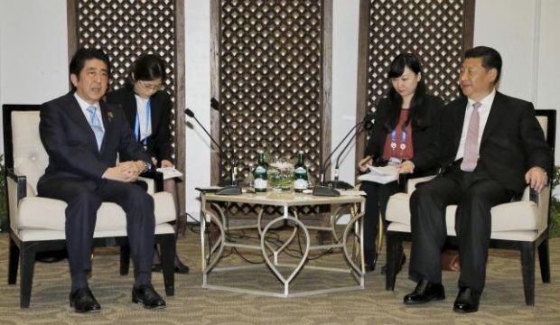 Japan's Prime Minister Shinzo Abe (L) talks with China's President Xi Jinping (R) during a bilateral meeting on the sidelines of the Asian–African Conference in Jakarta, Indonesia, in this photo released by Kyodo, on April 22, 2015. (Reuters/Kyodo)