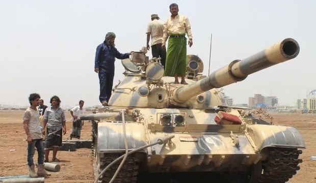 Yemeni supporters of the southern separatist Al-Hirak movement stand on a tank in the city of Aden on April 6, 2015, after fierce clashes raged between Houthi rebels and loyalist fighters in southern Yemen, leaving nearly 100 dead in 24 hours. (AFP Photo/Saleh Al-Obeidi)