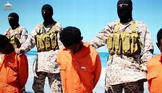 An image grab taken on April 19, 2015 from a video reportedly released by the Islamic State of Iraq and Syria (ISIS) group through Al-Furqan Media, one of the Jihadist platforms used by the militant organization on the web, purportedly shows men described as Ethiopian Christians captured in Libya kneeling on the ground in front of masked militants before their beheading on a beach at an undisclosed location in Libya. (AFP Photo)