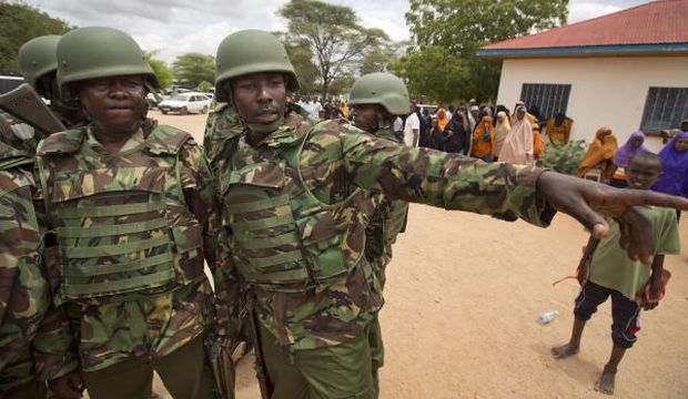 In this photo taken Saturday, April 4, 2015, Kenya Defense Forces (KDF) soldiers arrive at a hospital to escort the bodies of Al-Shabaab militants who attacked the Garissa University College campus on April 2, 2015 to be put on public view, in Garissa, Kenya. (AP Photo/Ben Curtis)