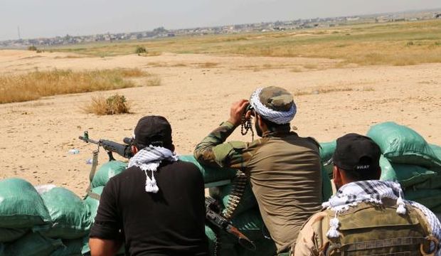 Iraqi Kurdish Peshmerga forces and Iraqi volunteer groups hold a position close to the village of Bashir in the Daquq district, 28 miles (45 kilometers) south of Kirkuk, Iraq, on April 18, 2015 as they launched an operation aiming to recapture nearby villages from the Islamic State of Iraq and Syria (ISIS) group. (AFP Photo/Marwan Ibrahim)