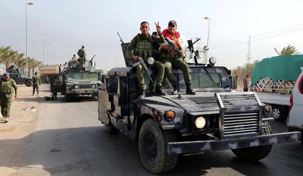 Iraqi security troops from Baghdad head to Ramadi on the orders of Prime Minister Haider Al-Abadi to reinforce troops there in their fight against the Islamic State of Iraq and Syria, on April 18, 2015. (AP Photo/Karim Kadim)