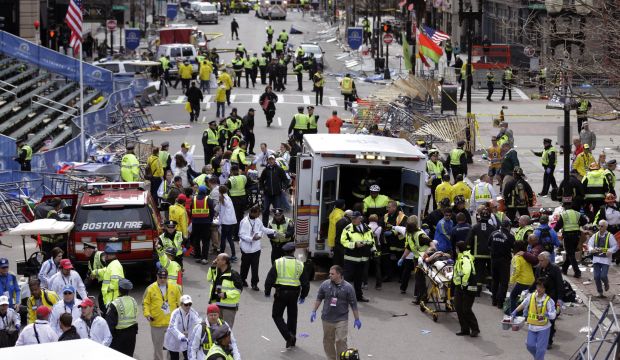 In this April 15, 2013 file photo, medical workers aid injured people following an explosion at the finish line of the Boston Marathon. (AP Photo/Charles Krupa, File)