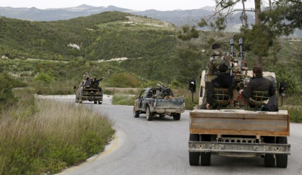 Rebel fighters drive in a convoy as they head towards what they said was an offensive to take control of the northwestern town of Jisr Al-Shughour and the surrounding areas, which are controlled by forces loyal to Syria's President Bashar Al-Assad April 20, 2015. (Reuters/Khalil Ashawi) 