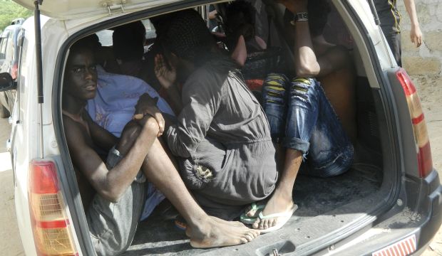 Students of the Garissa University College take shelter in a vehicle after fleeing from an attack by gunmen in Garissa, Kenya, on April 2, 2015. (AP Photo)