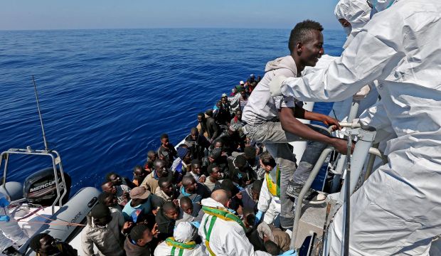 A picture made available on 23 April 2015 shows some of over 200 illegal migrants, as they are rescued and to be shipped to the Italian mainland by the Italian Guardia di Finanza boat 'Denaro' in the Mediterranean Sea, 22 April 2015. (EPA)