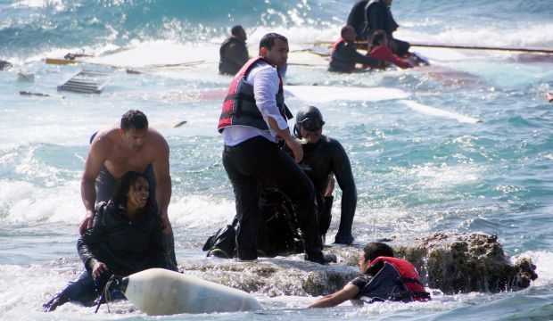 Greek army Sgt. Antonis Deligiorgis (L) rescues migrant Wegasi Nebiat from Eritrea from the Aegean sea, on the island of Rhodes, Greece on April 20, 2015. (Argiris Mantikos/Eurokinissi via AP, File)
