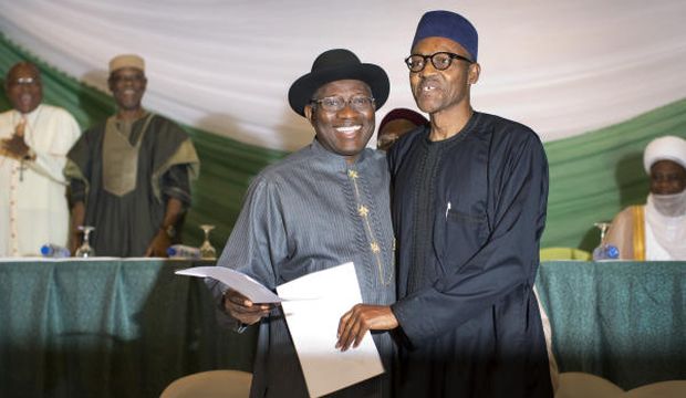 Goodluck Jonathan (L) and Muhammadu Buhari embrace after signing a peace accord ahead of the presidential elections in Abuja on March 26, 2015. (Reuters/Stringer)