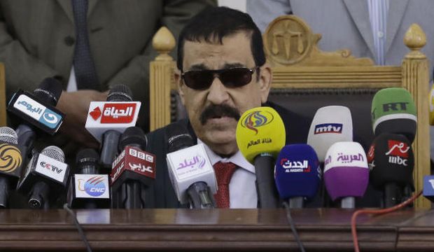 Egyptian Judge Mohamed Nagi Shehata reads the verdicts in a case that has become known as the "Rabaa Operations Room" trial in Cairo, Egypt, on April 11, 2015. (AP Photo/Hassan Ammar)