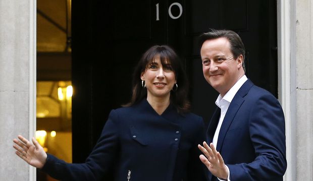 Britain's Prime Minister David Cameron and his wife Samantha return to 10 Downing Street in London on May 8, 2015. (AP Photo/Kirsty Wigglesworth)