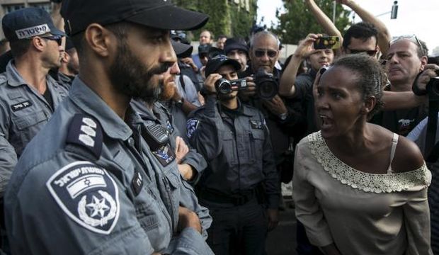 A protester, who is an Israeli Jew of Ethiopian origin, shouts at a policeman during a demonstration against what the minority community says is police racism and brutality, after the emergence last week of a video clip that showed policemen shoving and punching a black soldier, during a protest in Tel Aviv, on May 3, 2015. (Reuters/Baz Ratner)
