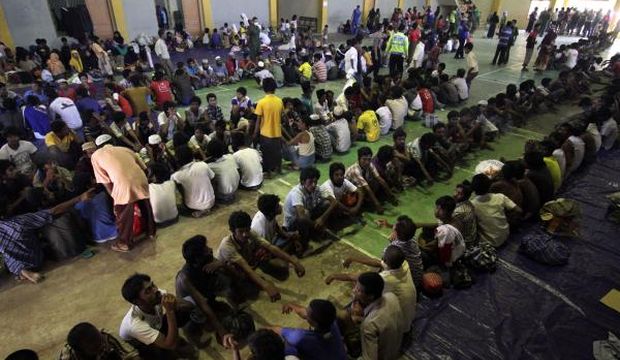Rohingya refugees line up for breakfast in the sport stadium of Lhok Sukon, North Aceh, Sumatra, Indonesia, on May 11, 2015, after being rescued from a boat off the North Aceh coast. (EPA/Zikri Maulana)