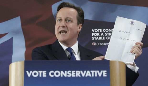 British Prime Minister David Cameron holds up a photocopied note left by former chief secretary to the Treasury Liam Byrne on his desk after Labour's 2010 election defeat, which reads "Dear Chief Secretary, I'm afraid there is no money. Kind regards—and good luck! Liam." as he delivers a speech at the Ambleside Sports Club in Nuneaton, England, on May 3, 2015. Britain goes to the polls in a General Election on May 7. (AP Photo/Tim Ireland, Pool)