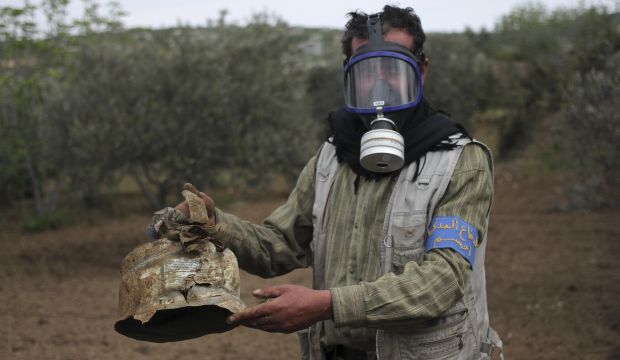 A Civil Defence member carries a damaged canister in Ibleen village from what activists said was a chlorine gas attack, on Kansafra, Ibleen and Josef villages, Idlib, Syria, on May 3, 2015. (Reuters/Abed Kontar)