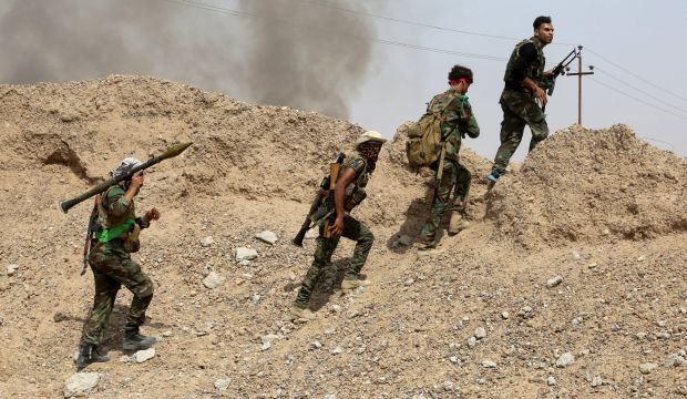 Iraq's Shi'ite paramilitaries walk with their weapons in Nibai May 26, 2015. (Reuters)