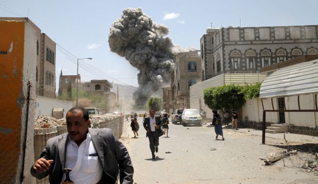 People flee as smoke billows after airstrikes hit the house of Yemen's former president Saleh in Sana'a on May 10, 2015. (Reuters/Mohamed Al-Sayaghi) 